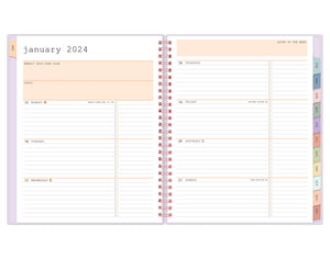 January 2024 - December 2024 planner featuring a weekly spread with lined writing space for each day and bullet points with multi-colored monthly tabs and rose gold twin wire-o binding in 7x9 planner size