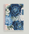 January 2024 - December 2024 WAAV Planner featuring shades of blue and white roses with green petals in a 5.875x8.625 planner size with rose gold binding.