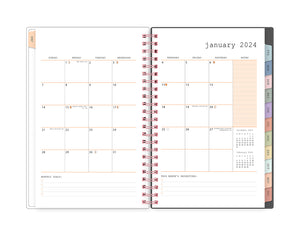 January 2024 - December 2024 planner featuring a monthly spread with blank writing space for each day and bullet points with multi-colored monthly tabs and rose gold twin wire-o binding in 5.875x8.625 planner size
