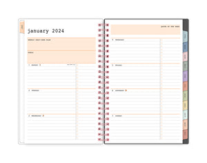 January 2024 - December 2024 planner featuring a weekly spread with lined writing space for each day and bullet points with multi-colored monthly tabs and rose gold twin wire-o binding in 5.875 x 8.625 planner size.
