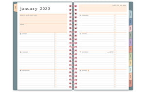 january 2023 - december 2023 weekly monthly planner featuring ample ined writing space, bullet points, and multi-colored monthly tabs for all your notes, goals, to do's and plans for the week on a 5x8 planner