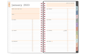 january 2023 - december 2023 weekly monthly planner featuring ample ined writing space, bullet points, and multi-colored monthly tabs for all your notes, goals, to do's and plans for the week on a 5x8 planner