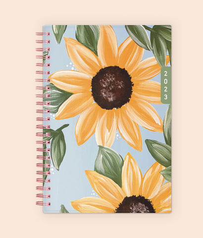 This beautiful 2023 waav planner in 5x8 size features a pleasant and calm sunflower design with light sky blue background and gold binding.