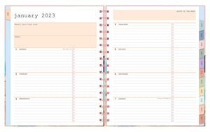 january 2023 - december 2023 weekly monthly planner featuring ample ined writing space, bullet points, and multi-colored monthly tabs for all your notes, goals, to do's and plans for the week on a 7x9 planner