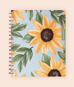 This beautiful 2023 waav planner in 7x9 size features a pleasant and calm sunflower design with light sky blue background and gold binding.